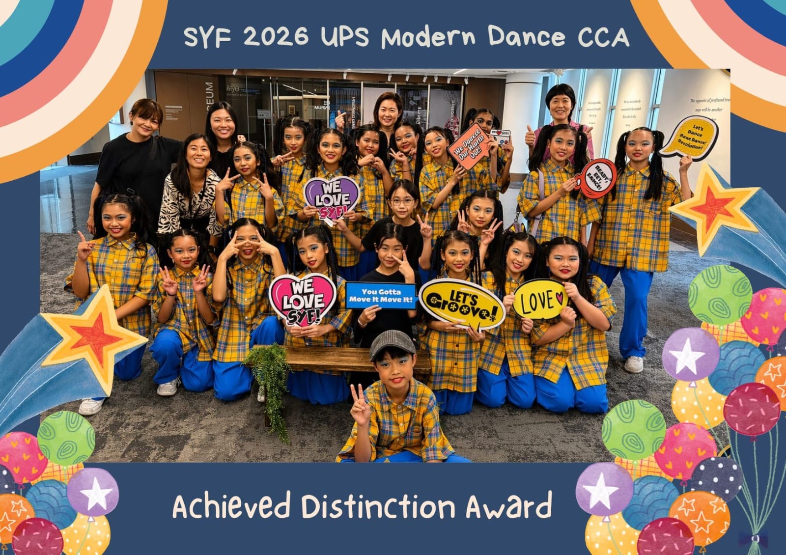 A group of dance students showing peace sign and taking a group photo